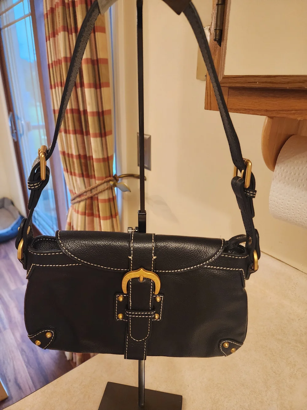 vintage Dooney & Bourke black leather shoulder bag featuring gold-tone hardware
